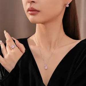 French style silver jewelry set with pink flower zircon pendant worn by a model.