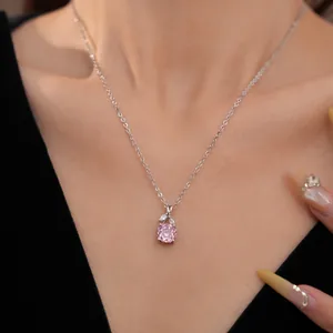Elegant close-up view of a pink floral zircon necklace on a silver chain worn by a model