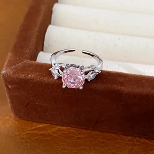 Detailed macro view of a silver ring with a central pink zircon and accent stones.