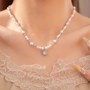 Detailed shot of an elegant beaded pearl necklace featuring a square zircon pendant on a model