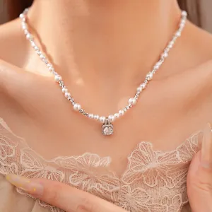 Elegant beaded pearl necklace featuring a square zircon pendant on a model's collarbone