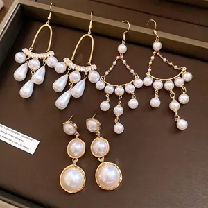 Eleganti orecchini pendenti con perle di lusso francese su vassoio scuro