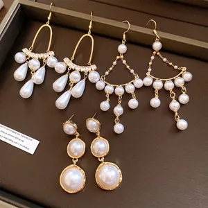 Detailed view of three styles of French luxury pearl earrings with elegant gold plating.