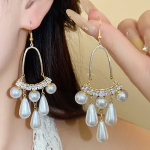 Detailed close-up of elegant French luxury pearl tassel drop earrings with crystals