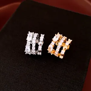 Vue détaillée de boucles d'oreilles plaquées or 18 carats avec trois rangées de zircons