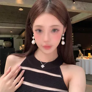 French style elegant cascading pearl drop earrings worn by model for a luxury look