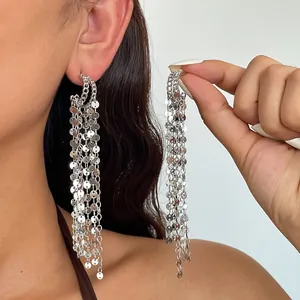 Metallic silver tassel earrings with round sequins shown worn and held for detail