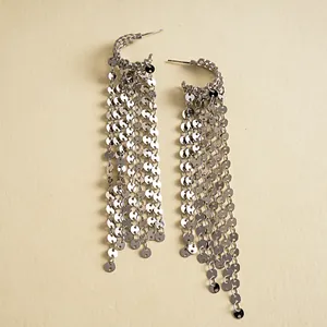 Detailed view of silver sequin tassel earrings with tiered metal disc fringe design.