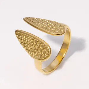 Detailed view of a gold-plated stainless steel open ring featuring a unique wing texture.