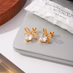 Close-up of 18k gold plated stainless steel heart zircon bow-knot stud earrings
