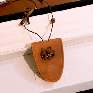 Gros plan détaillé de l'ornement en résine de chat sur un collier porte-lunettes en daim