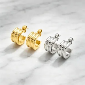 Triple-layered stainless steel C-shaped hoop earrings in gold and silver finishes