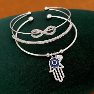 Silbernes Armreif-Set mit Unendlichkeitszeichen und Hamsa-Hand-Anhänger aus Zirkon