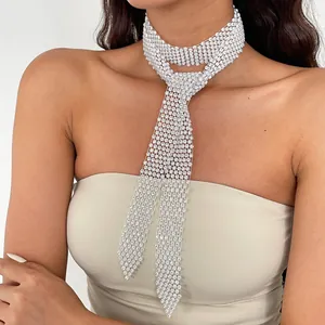 Detail view of an elegant white rhinestone woven necktie choker necklace worn by a model