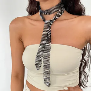 Detail view of a luxury sparkling rhinestone mesh necktie necklace worn by a model