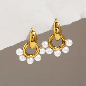 Gold plated stainless steel earrings with resin pearls in a unique door knocker design.