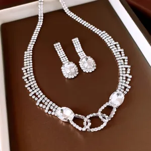 Detailed view of luxury silver-toned jewelry set with oval stones and pavé crystals