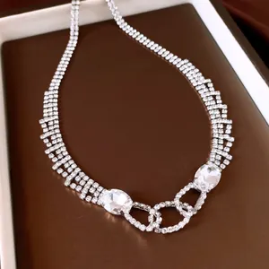 Detailed macro shot of shimmering rhinestone necklace featuring large oval crystal accents