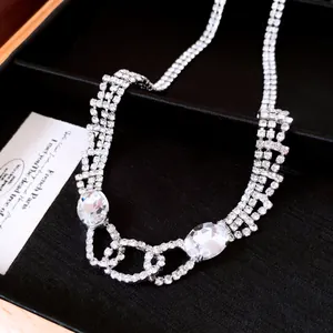 Detailed view of luxury multi-strand rhinestone necklace with oval crystals in black box.
