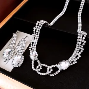Close-up of luxury silver-toned jewelry set with oval rhinestones and sparkling crystals