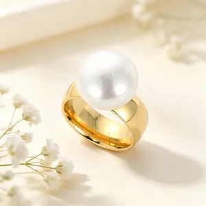 Detailaufnahme eines eleganten breiten Goldedelstahlrings mit einer großen weißen Perle