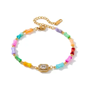 Detailed view of colorful bamboo beads and a sparkling zircon centerpiece on a gold bracelet
