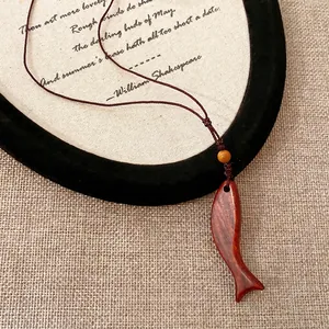 Vintage hand-carved wooden fish pendant necklace with brown woven cord chain