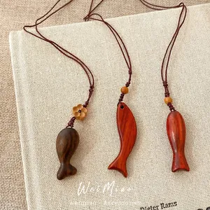 Handcrafted wooden fish pendant necklaces on adjustable brown woven ropes for women