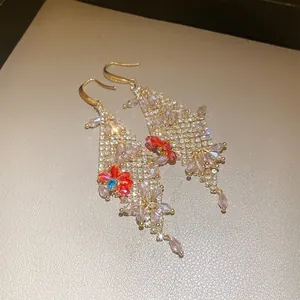 Elegant dangling earrings featuring rhinestone mesh and colorful crystal flower accents