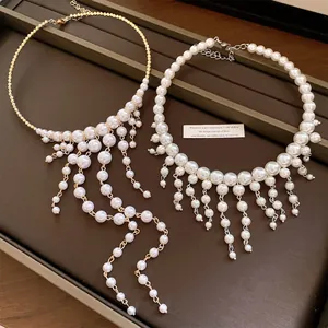 Two styles of elegant French palace pearl choker necklaces with tassel details.
