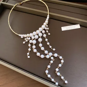 Detail view of a French palace style pearl choker featuring an elegant tassel design.