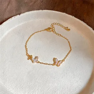 Detailansicht eines 14K vergoldeten Armbands mit Zirkon- und rosa Emaille-Schmetterlingen.