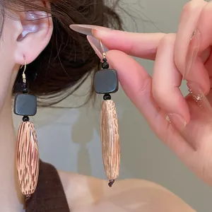 Gros plan détaillé de boucles d'oreilles ethniques en bois à motifs géométriques