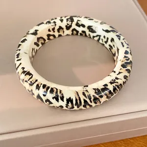 Stylish round resin bangle featuring a classic leopard print pattern for women