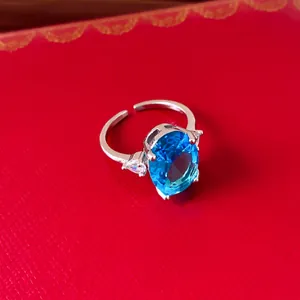 Macro view of vintage silver adjustable ring with large oval blue zircon stone