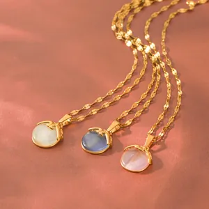 Macro view showing three colors of cat eye stone pendants with elegant gold chains