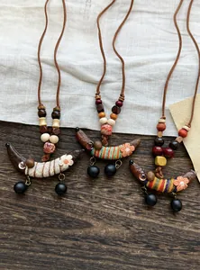 Handgefertigte Ethno-Holzkette mit bunten Erbsenanhängern und floralen Stickdetails