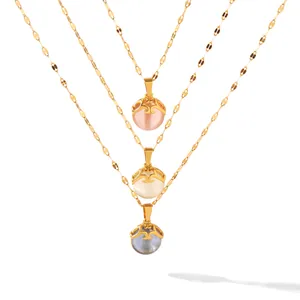 Detailed view of cat eye stone pendants in pink, white, and blue with gold chain