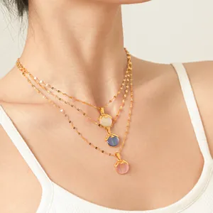 Close-up of three layered cat eye stone necklaces in gold-tone titanium steel