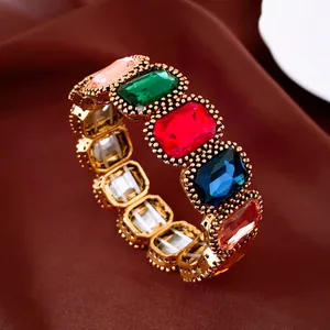 Gedetailleerd aanzicht van een gouden vintage armband met grote kleurrijke stenen