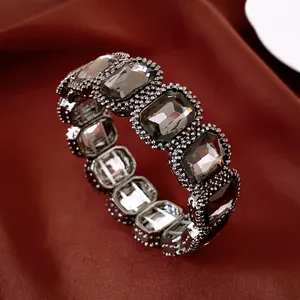 Macro-opname van een luxe rekbare armband met donkergrijze kristallen op zijde