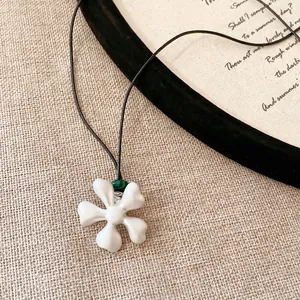 Elegant ceramic flower pendant necklace with malachite bead on black leather cord