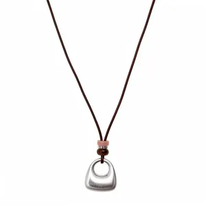 Minimalist brown leather cord necklace with silver geometric pendant and beads.
