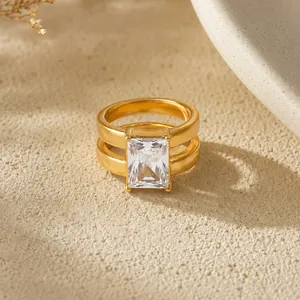 Close-up of double-layered 18K gold plated stainless steel ring with emerald cut zircon