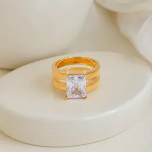 Close-up detail of a geometric double-layer 18K gold plated ring with a square zircon.