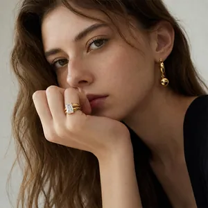 Close-up detail of a double-layer 18K gold-plated titanium steel ring with square zircon