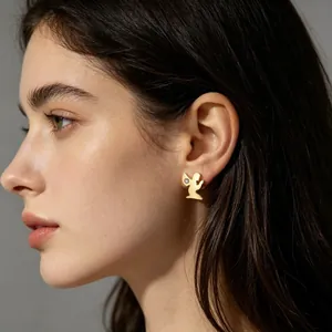 Gros plan d'une boucle d'oreille ange dorée style découpé avec diamant sur un mannequin