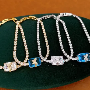 Dettaglio di bracciali tennis placcati in oro e argento con ciondoli a farfalla