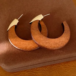 Retro French style wooden C-shaped hoop earrings with gold-toned metal accents