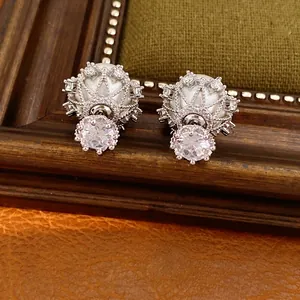 Elegant silver-tone stud earrings featuring round pearls and sparkling zircon accents